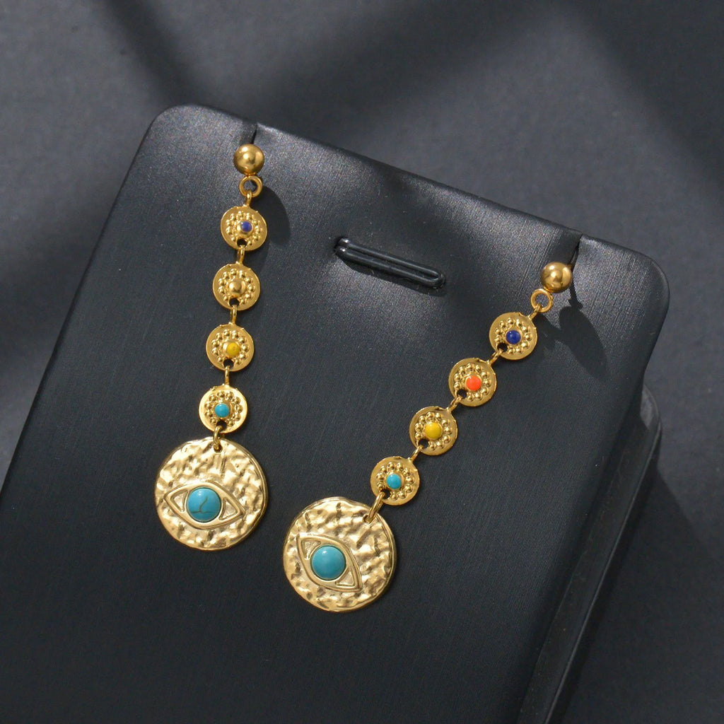 Geometric stainless steel earrings showing eight awn star, eye pattern, and shell sun designs