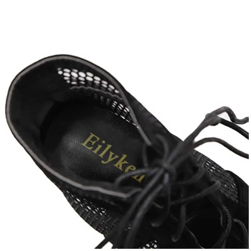 Black suede women's lace-up high heel shoes with a high stiletto heel and a front platform.