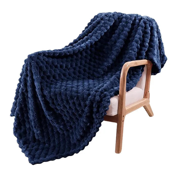Soft polyester velvet children's plaid blanket in camel colour, shown in a 90x90 inch size on a bed.