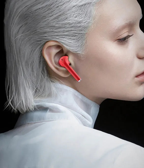 Black lipstick case open to reveal matching wireless Bluetooth earbuds with a contoured in-ear design.