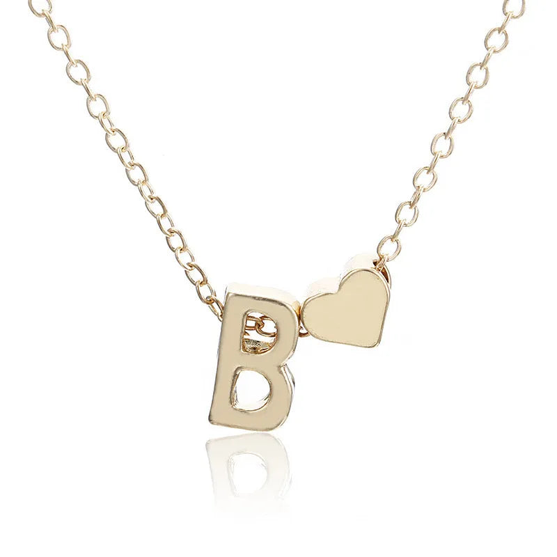 Peach heart shaped letter necklace pendant in gold alloy on display