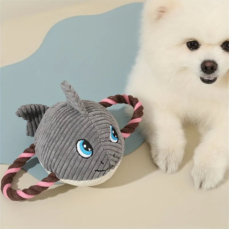 Grey, green, and orange turtle-shaped stuffed dog knot chewing toy on a plain background.