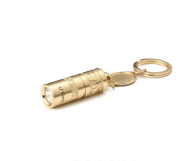Gold-coloured zinc alloy mini LED keychain flashlight with a keyring.