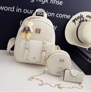 Women's three-piece PU leather bag set showing backpack, shoulder bag and card holder in a floral design.