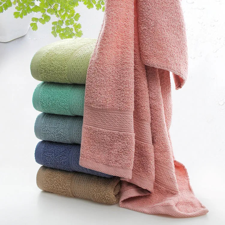 Thickened cotton blend bath and beach towel in solid colour options including green, blue, and pink.