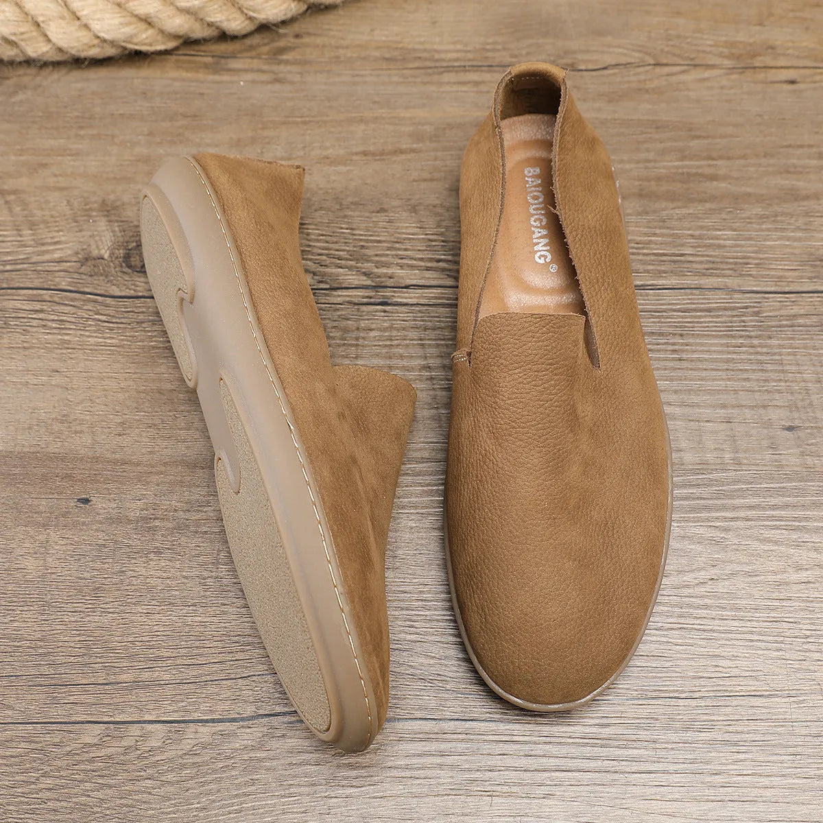 Handmade grey low-top men's shoes with a flat wedge heel and rubber sole.