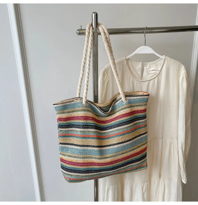 Blue straw woven large capacity single shoulder bag with nylon exterior and polyester lining.