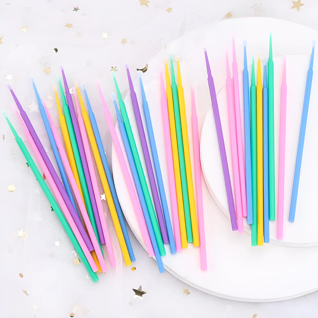 Disposable micro applicator brushes with bendable cotton swab heads and coloured handles for makeup and eyelash extensions