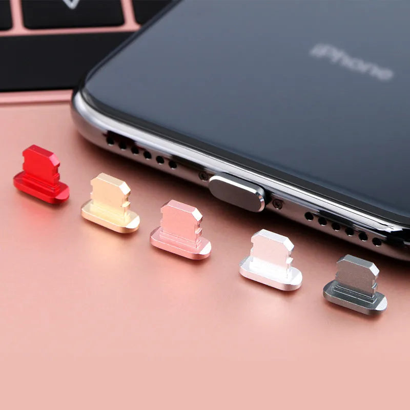Aluminium alloy dust plug for iPhone charging port in various colours including gold and rose gold.