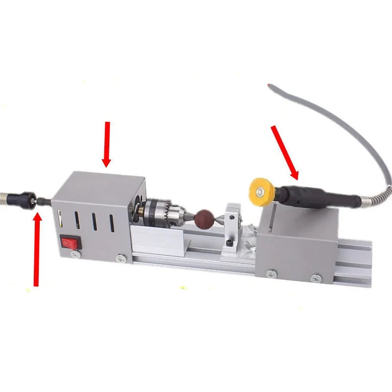 Mini metal manual woodworking lathe with carving knives on a workshop bench