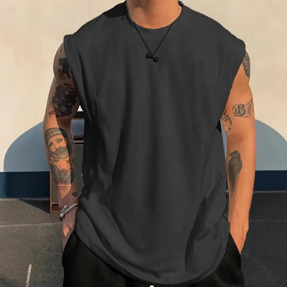 Men's loose fit solid colour cotton tank top on a hanger, shown in apricot colour.