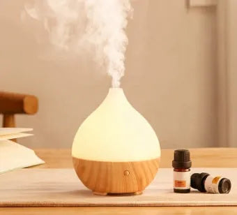 Wood grain finish vase-shaped aroma diffuser with 100ml water tank capacity.