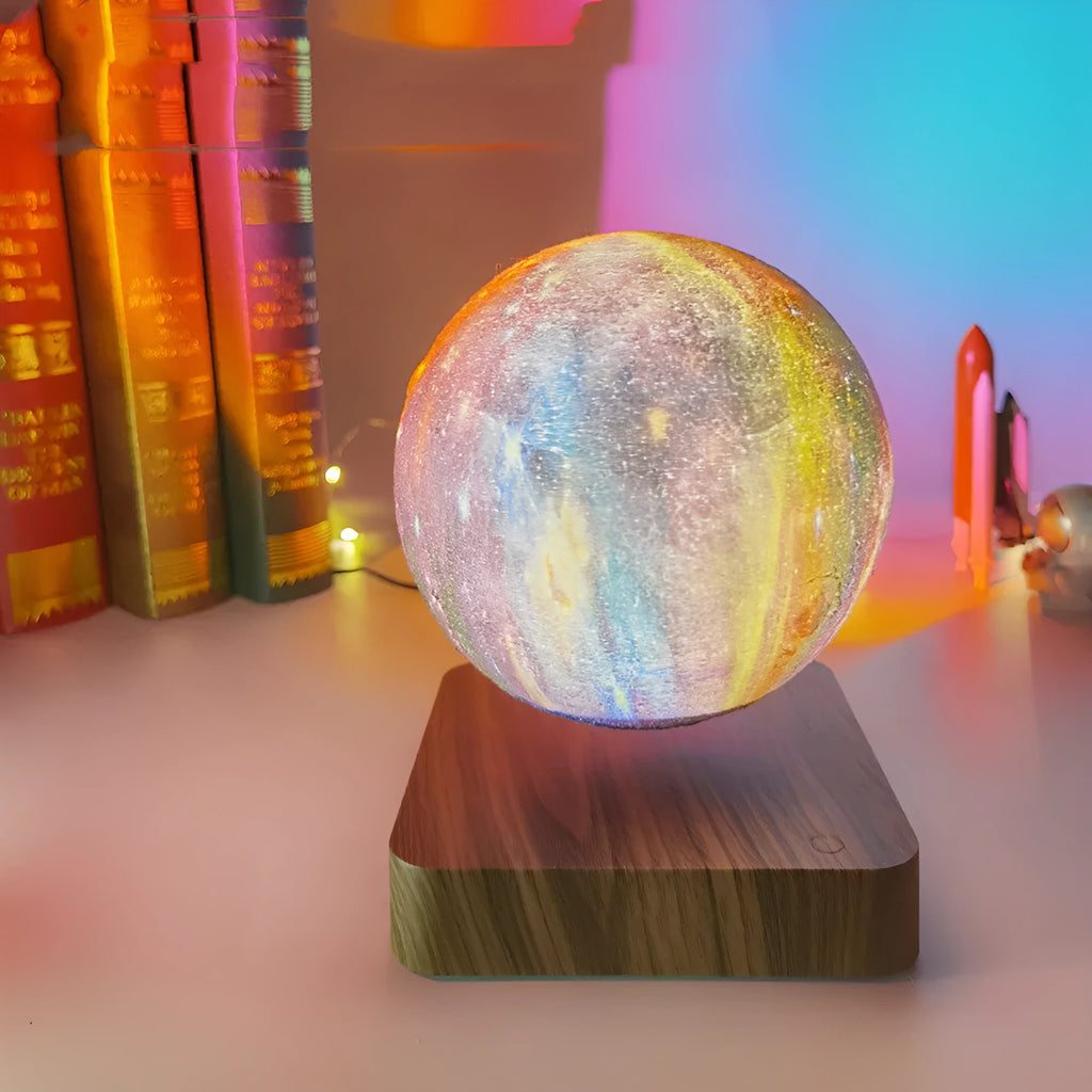 Square walnut coloured base with a levitating, glowing galaxy-patterned moon lamp above it