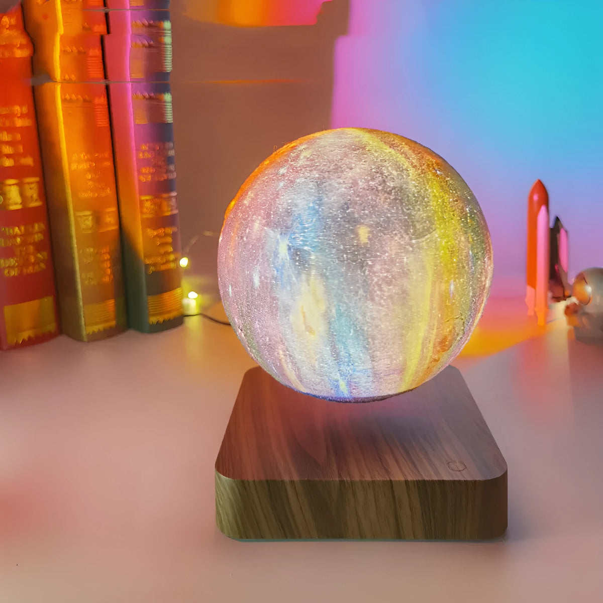 Square walnut coloured base with a levitating, glowing galaxy-patterned moon lamp above it