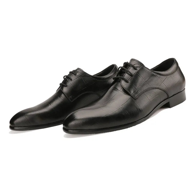 Men's black handmade cow leather derby shoes with pointed toe and checkered sewing pattern on a rubber sole.