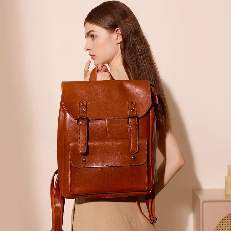 Women's cowhide leather computer backpack in black, brown, or coffee with hard structure and wear-resistant finish