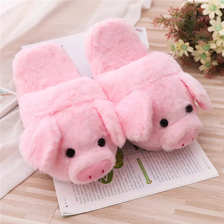 Pink plush pig-themed floor slippers on a white background.