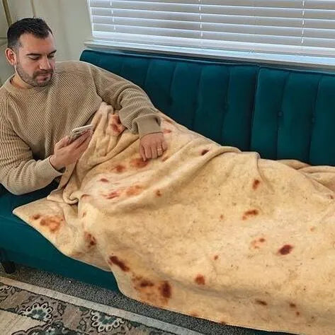 Round coral fleece burrito blanket with a food-themed print, shown folded.
