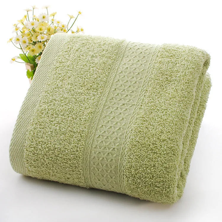 Thickened cotton blend bath and beach towel in solid colour options including green, blue, and pink.