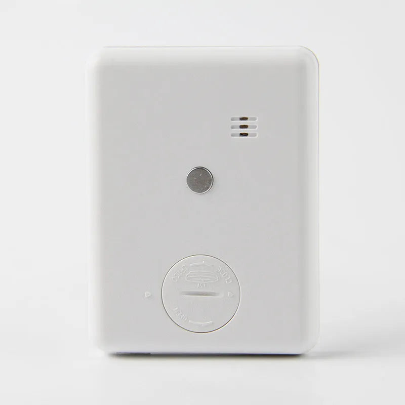 Black and white digital kitchen timer with magnetic back and display showing time