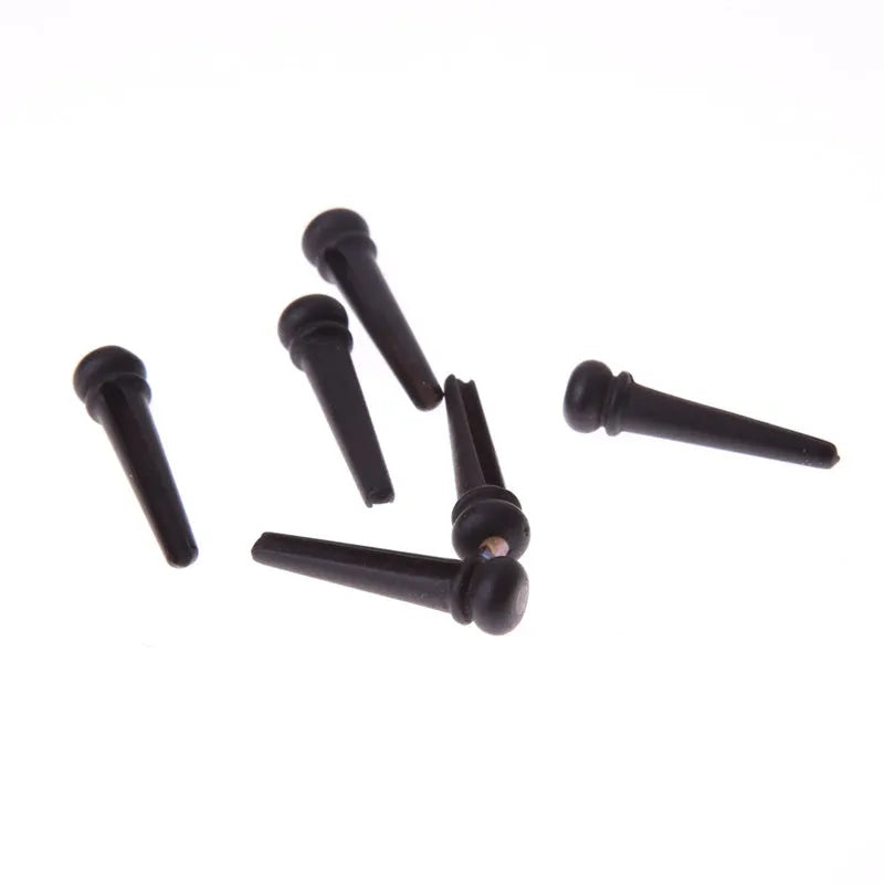 Six matt black ebony guitar string nails with a 5.3mm bayonet diameter for folk acoustic guitars.