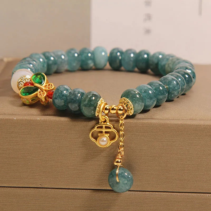 Blue water jade abacus bead crystal bracelet with butterfly charm and white agate beads