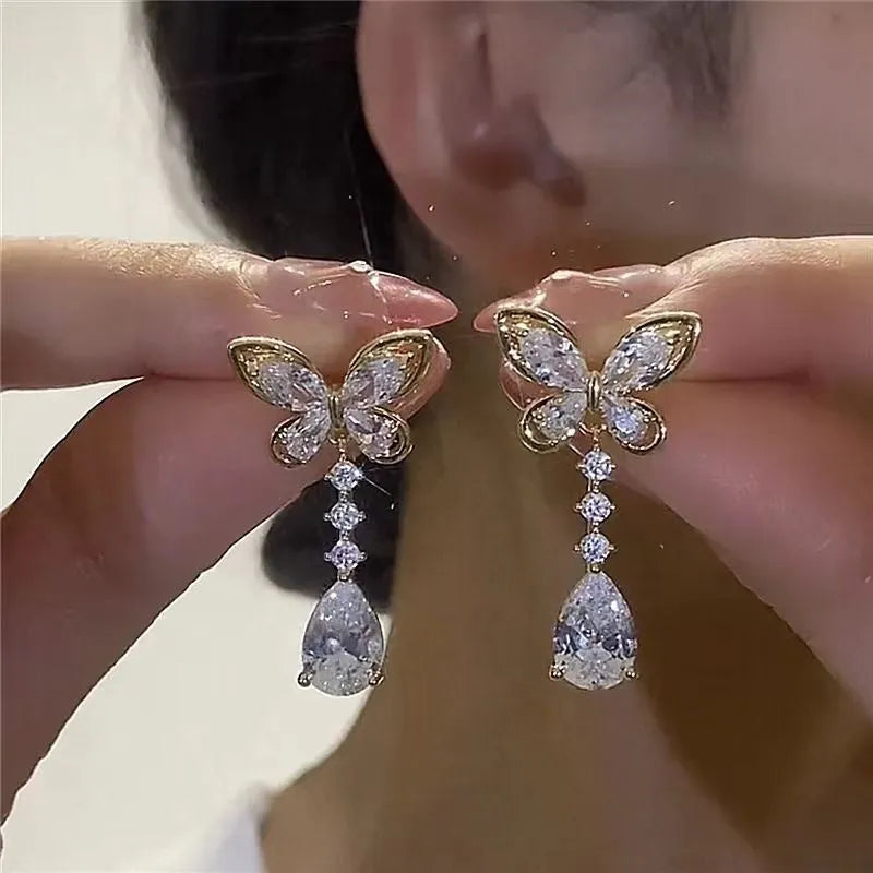 Women's platinum bow stud earrings with zinc alloy construction and electroplated finish