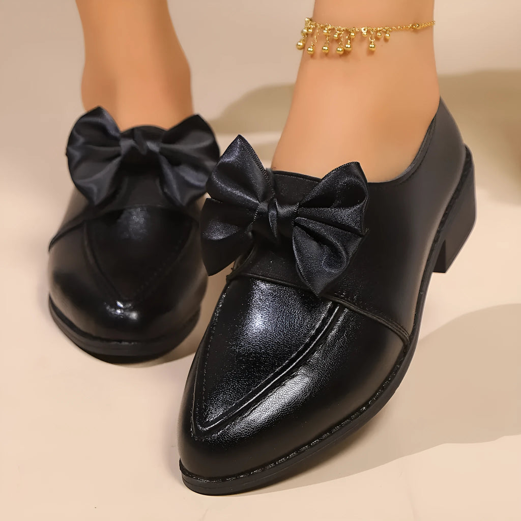Women's British-style flat shoes with bow detail, pointed toe, and rubber sole