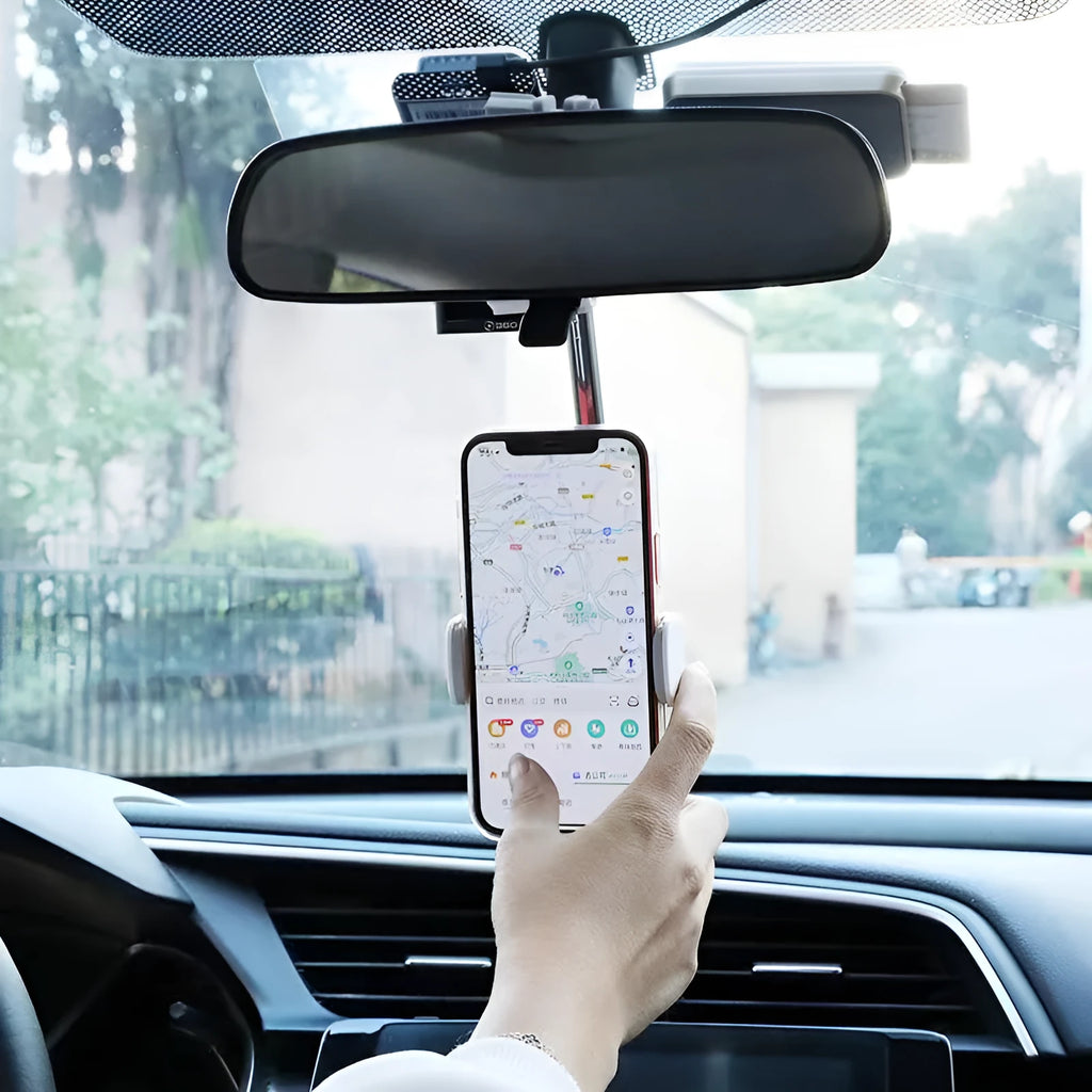 Black ABS plastic phone bracket mounted on car rearview mirror holding smartphone