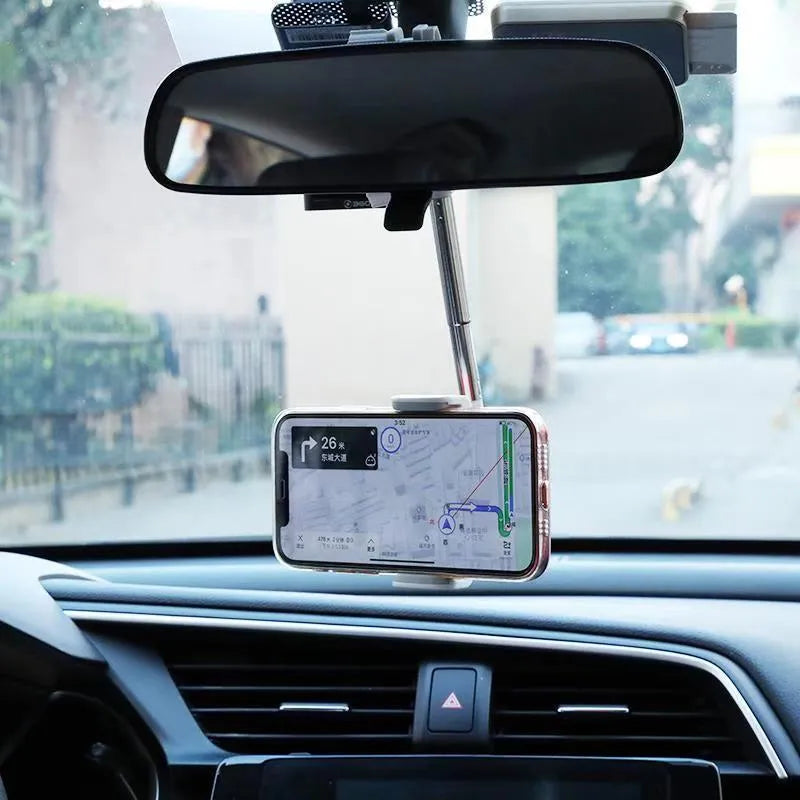 Black ABS plastic phone bracket mounted on car rearview mirror holding smartphone