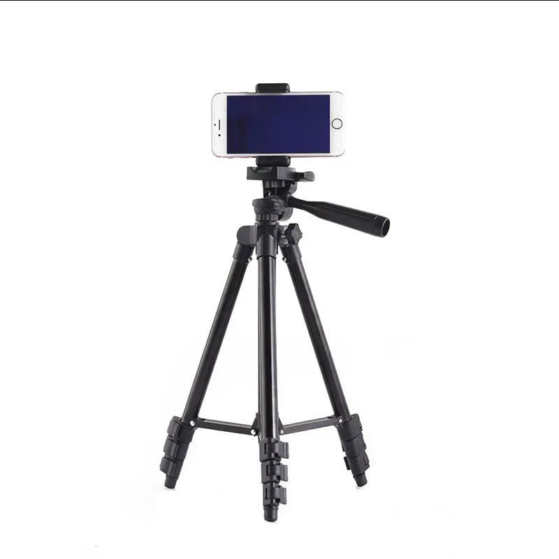 Black aluminium portable camera tripod with quick-release plate extended to medium height