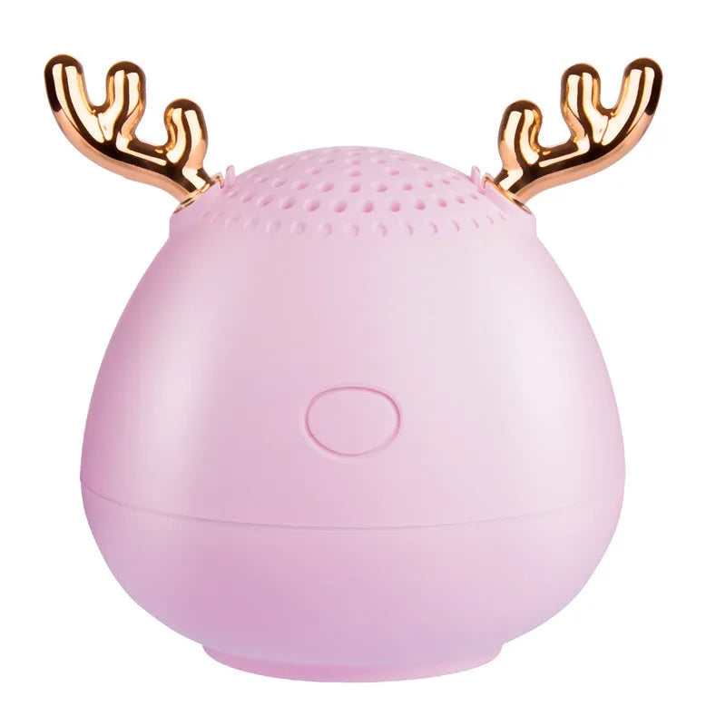 Small green portable Bluetooth speaker with USB cable on a white background.