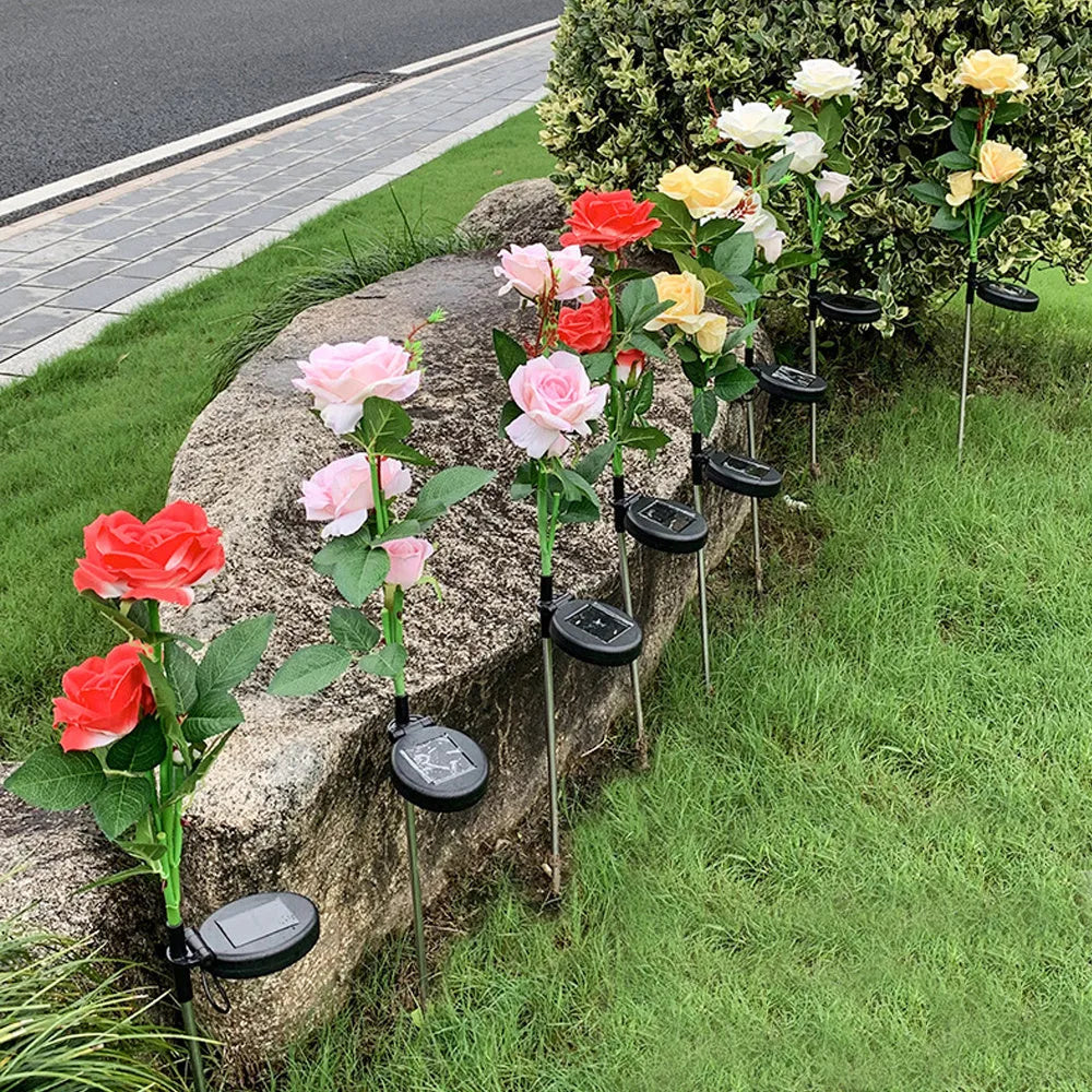 Outdoor solar rose garden lamp with three heads on an 80cm stake, showing pink silk cloth roses with LED illumination.