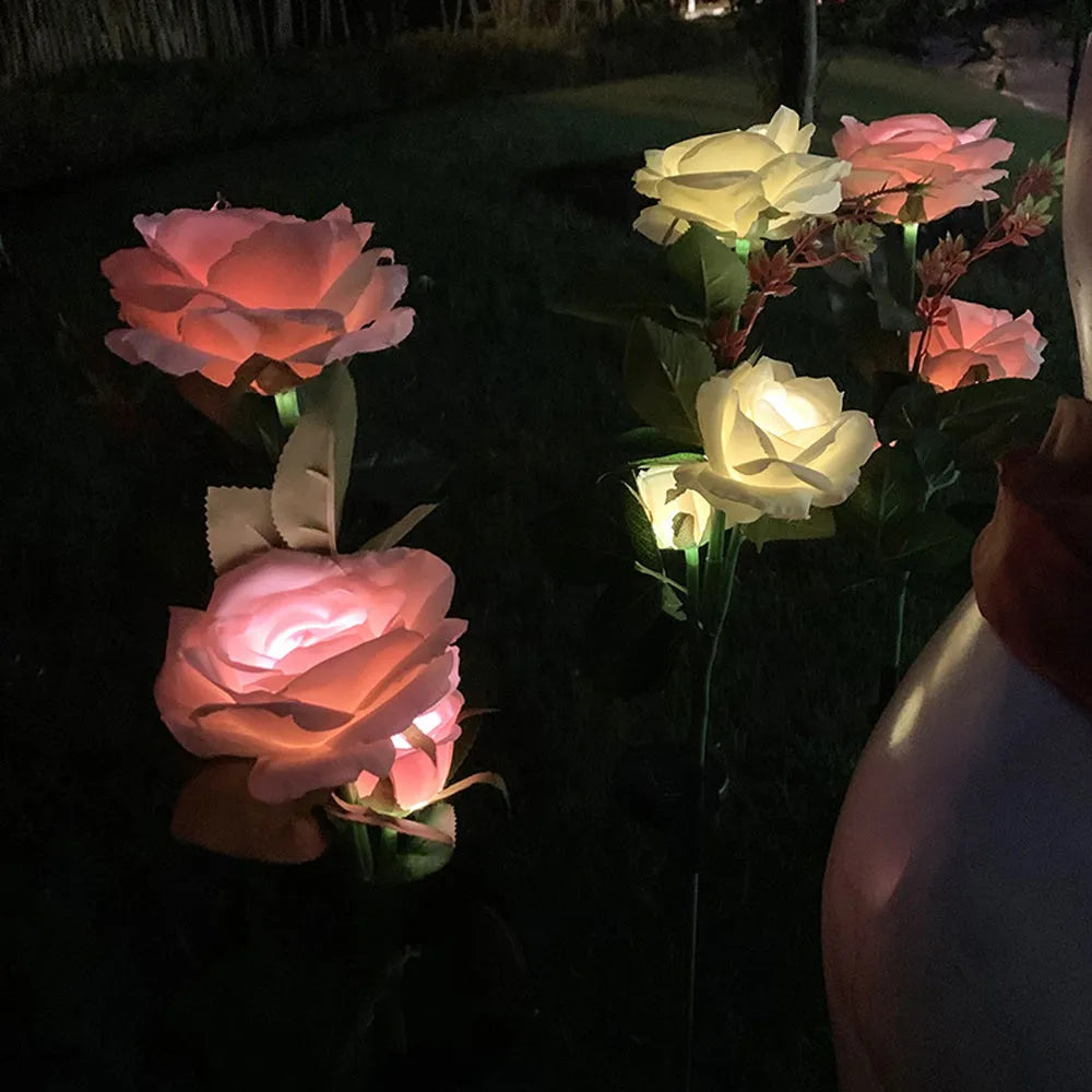 Outdoor solar rose garden lamp with three heads on an 80cm stake, showing pink silk cloth roses with LED illumination.