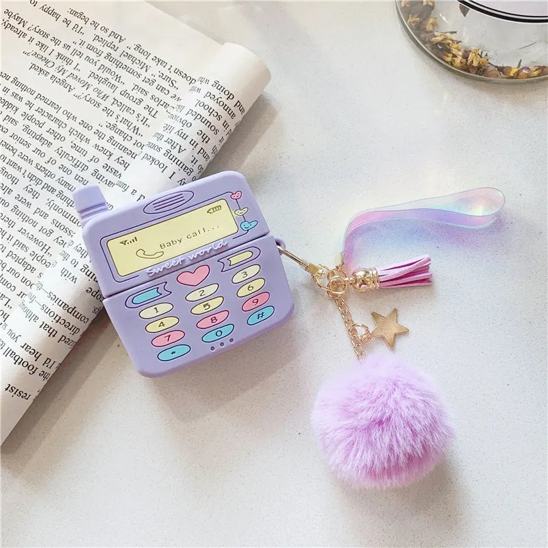 Purple silicone protective case for Apple AirPods with fur ball pendant, showing clamshell design