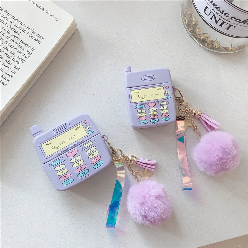 Purple silicone protective case for Apple AirPods with fur ball pendant, showing clamshell design