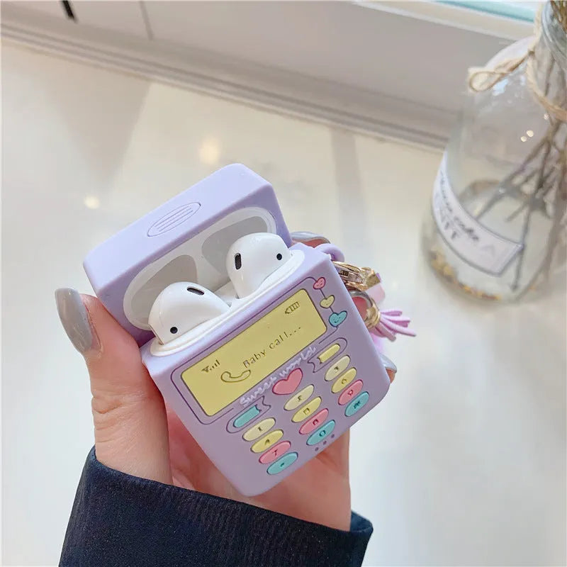 Purple silicone protective case for Apple AirPods with fur ball pendant, showing clamshell design