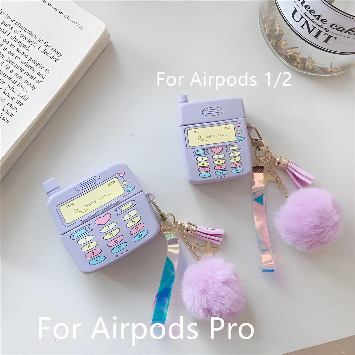 Purple silicone protective case for Apple AirPods with fur ball pendant, showing clamshell design