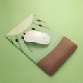 Cute design silicone and cloth wrist mouse pad with thickened support, shown on a desk.