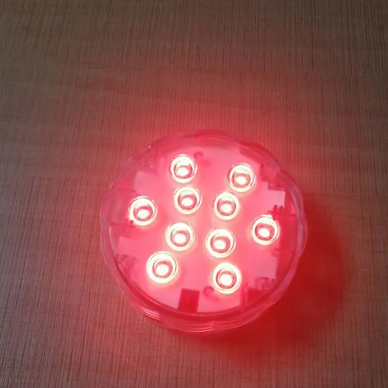 White IP68 waterproof LED diving light with remote control for pools and gardens.