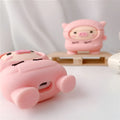 Pink silicone AirPods case with cartoon hoodie pig design, showing flip opening and attachment hook