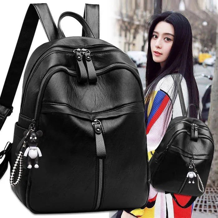 Black PU leather backpack with luggage straps showing ID compartment and zipper opening
