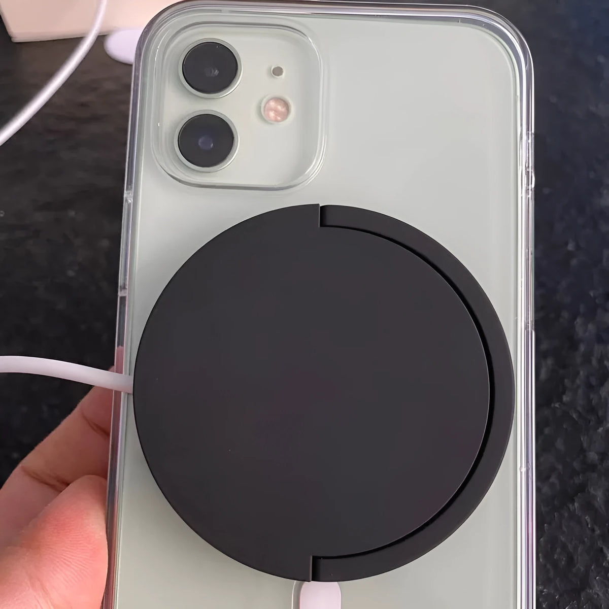 Black magnetic wireless charging bracket holding mobile phone at adjustable angle