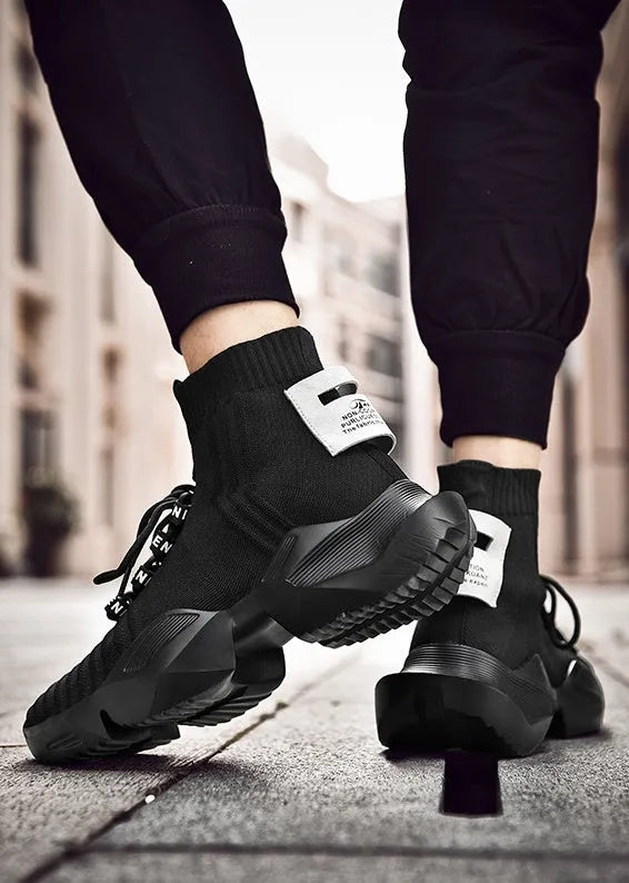 Men's black and white casual sports shoes with mesh lining, shown in larger sizes.