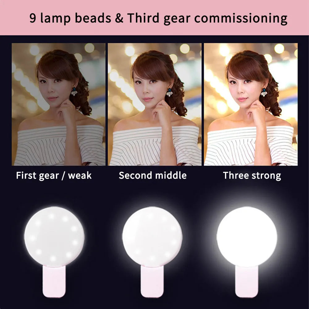 Small round white clip-on LED fill light attached to a mobile phone for selfie photography.
