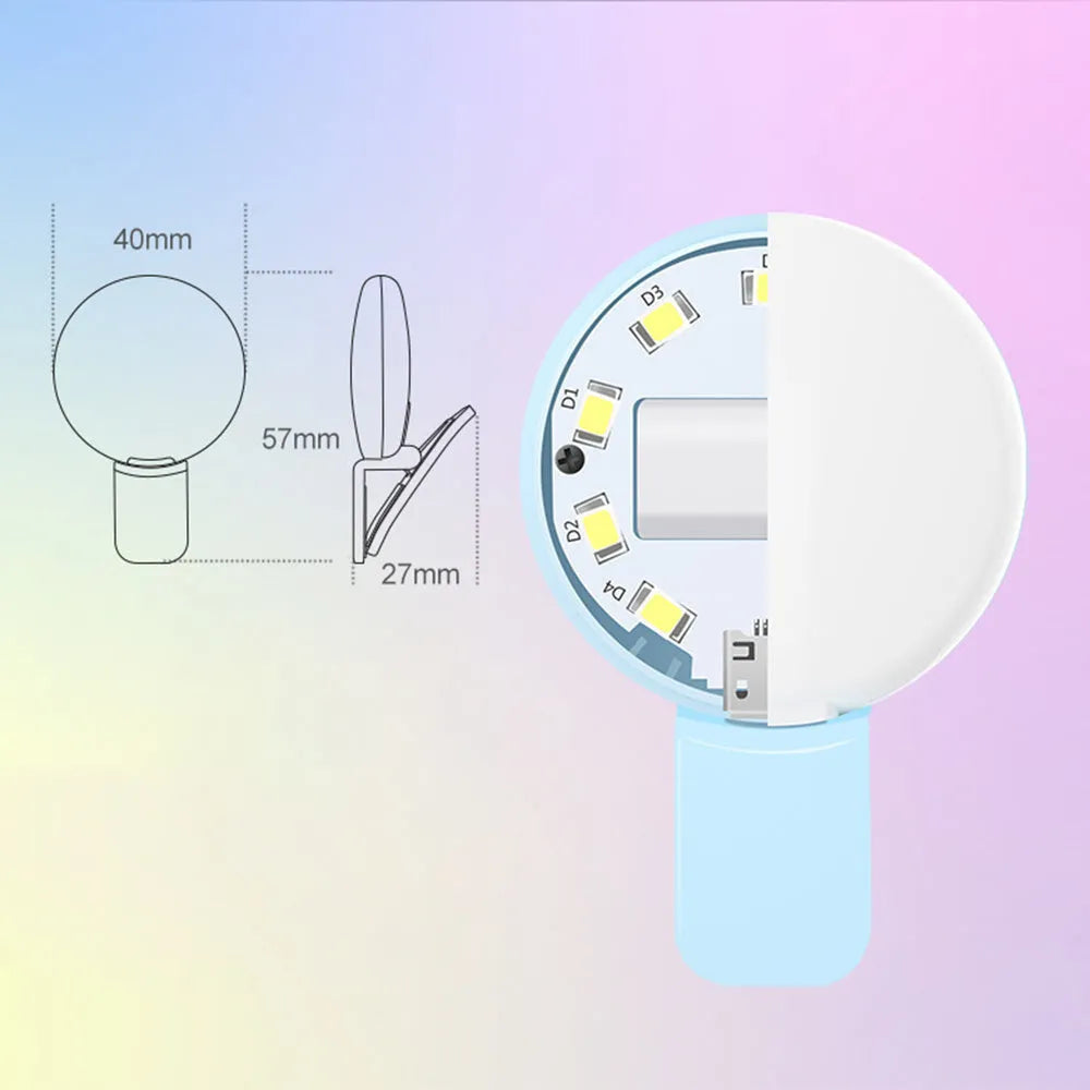 Small round white clip-on LED fill light attached to a mobile phone for selfie photography.