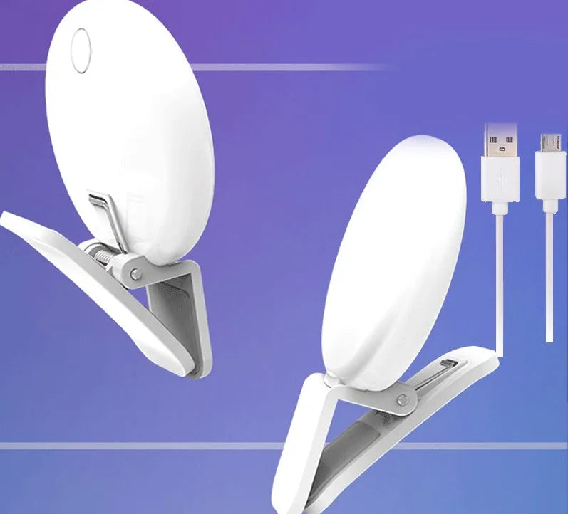 Small round white clip-on LED fill light attached to a mobile phone for selfie photography.