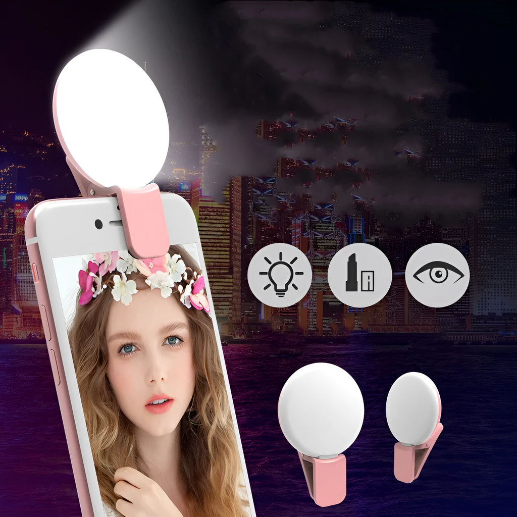 Small round white clip-on LED fill light attached to a mobile phone for selfie photography.