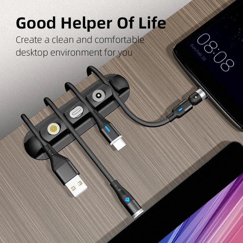 Black soft plastic desktop magnetic charging cable organiser on a desk