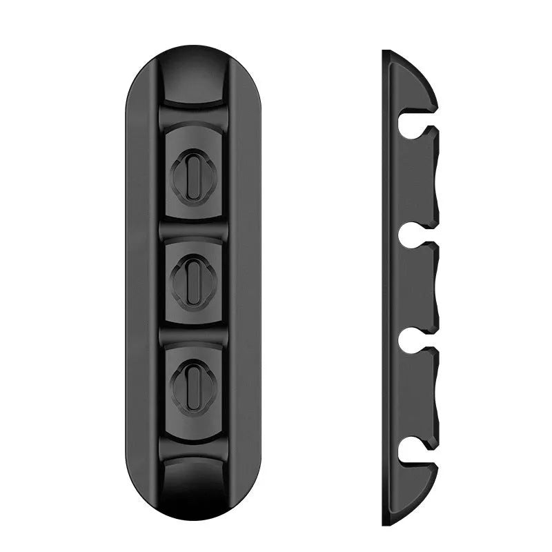 Black soft plastic desktop magnetic charging cable organiser on a desk